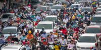 HANOI, VIETNAM - MAY 19: Motorbike riders with face masks are stuck in traffic during the morning peak hour on May 19, 2020 in Hanoi, Vietnam. Though some restrictions remain in place, Vietnam has lifted the ban on certain entertainment facilities and non-essential businesses, including pubs, cinemas and spas &amp; other tourist attractions to recover domestic tourism. On April 23, the Ministry of Transport started to increase domestic flights and trains to major destinations with limited passenger capacity. As of May 19, Vietnam has confirmed 324 cases of coronavirus disease (COVID-19 ) with no deaths in the country, 263 fully recovered and no new case caused by community transmission for 33 days. (Photo by Linh Pham/Getty Images)