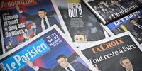 Front pages of the French newspapers show the centrist incumbent President Emmanuel Macron after beating his far-right rival Marine Le Pen for a second five-year term on 25 April 2022. (Photo: Jeff J Mitchell / Getty Images)
