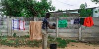 Advance Tshuma, 21, washes clothes at his family home on November 22, 2020, in Luveve, Bulawayo, Zimbabwe. Advance complains about the discolouration of his pricey clothes due to dirty water while others use it for household consumption. (Photo: Zinyange Auntony)