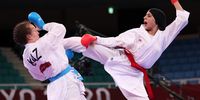 epa09404350 Feryal Abdelaziz of Egypt (R) and Sofya Berultseva of Kazakhstan (L) compete in their women's kumite +61kg semifinal bout during the Karate events of the Tokyo 2020 Olympic Games at the Nippon Budokan arena in Tokyo, Japan, 07 August 2021.  EPA-EFE/HEDAYATULLAH AMID