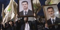 Supporters of Syrian President Bashar al-Assad hold his portrait in 2019 (Credit: EPA-EFE / Andre Pain)