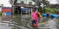 Sri Lankan flood victim wades through a flooded road after heavy rainfall in the suburb of Colombo, Sri Lanka, 14 October 2024.  According to the Sri Lanka Disaster Management Center, at least three individuals have been killed, and over 134,000 people have been affected around the country. Many parts of the island have been inundated due to heavy rains.  EPA-EFE/CHAMILA KARUNARATHNE