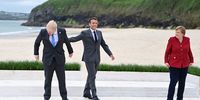 epa09262300 Britain's Prime Minister Boris Johnson (L), France's President Emmanuel Macron (C) and German Chancellor Angela Merkel (R) during the G7 Summit in Carbis Bay, Britain, 11 June 2021. Britain will held the G7 summit in Cornwall in from 11 to 13 June 2021.  EPA-EFE/NEIL HALL/INTERNATIONAL POOL
