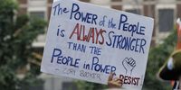An attendee holds a sign quoting Senator Cory Booker, while they and local union members attend a rally in support of union leader David Huerta and the protesters in Los Angeles, on the Boston City Hall Plaza in Boston, Massachusetts, USA, 09 June 2025. Huerta who was detained in Los Angeles, seen injured on television on 06 June 2025, was arrested while protesting a raid by Immigration and Customs Enforcement (ICE) division of the US Department of Homeland Security at a worksite in downtown Los Angeles and was accused of obstructing police officers.  EPA-EFE/CJ GUNTHER