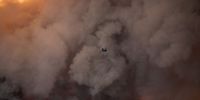 epa10997263 A Chinook helicopter operates over a wildfire near the village of Pournari, in Dervenochoria, northwest of the Attica region, Greece, 18 July 2023. Multiple wildfires have started in Greece since 17 July 2023 leaving at least 28 people dead and 75 injured, with 80 wildfires being recorded.  EPA-EFE/KOSTAS TSIRONIS