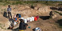 People draw water from a well on November 22, 2020, near Luveve in Bulawayo, Zimbabwe. The city council water browsers, which sometimes provide clean water haven't made delivery in days.  (Photo: Zinyange Auntony)