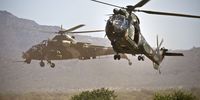 A South African Air Force Oryx helicopter flies past a Rooivalk helicopter during the air force capability demonstration at the Roodewal Bombing Range in 2013. (Photo: Gallo Images / The Times / Daniel Born)