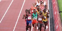 TOKYO, JAPAN - AUGUST 06: Paul Chelimo of Team USA, Milkesa Mengesha of Team Ethiopia, Nicholas Kipkorir Kimeli of Team Kenya and Joshua Cheptegei of Team Uganda compete in the Men's 5000 metres final on day fourteen of the Tokyo 2020 Olympic Games at Olympic Stadium on August 06, 2021 in Tokyo, Japan. (Photo by Ryan Pierse/Getty Images)