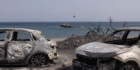 GENNADI, GREECE - JULY 27: A firefighting helicopter is framed by two burnt out cars as it scoops up water to take to a forest fire on July 27, 2023 in Gennadi, Rhodes, Greece. Firefighters continue to deal with wildfires on the island of Rhodes as Greece battles fires across the country during the continued heatwave. The fires on Rhodes prompted preventive evacuations of tens of thousands of tourists in the middle of the high summer season. (Photo by Dan Kitwood/Getty Images)