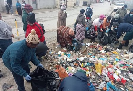 Battling a foul stench, residents clean up rubbish amid contractor's dispute with City of Cape Town