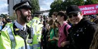 UK police officer shouts instructions at activists protesting against the DSEI arms fair, London, 9 September 2017. (Photo: Alisdare Hickson / Flickr)<br>