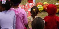 A group of youngsters at the Eastern Province Child and Youth Care Centre eagerly waits to open Christmas gifts on Friday. (Photo: Deon Ferreira)