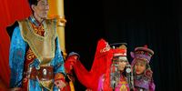World's tallest man Bao Xishun (L) as his bride Xia Shujuan is unveiled during their traditional Mongolian wedding ceremony at Genghis Khan's Mausoleum on July 12, 2007 in the outskirts of Erdos of Inner Mongolia Autonomous Region, China. The 54-year-old Mr Bao, who stands at 2.36m (7ft 8.95in) tall, registered marriage with Xia Shujian, a 29-year-old saleswoman from his home city of Chifeng on March 26, 2007. Bao was confirmed as the world's tallest living man by Guinness World Records last year. (Photo by China Photos/Getty Images)