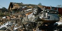 An overturned vehicle amid destroyed homes following a tornado in Arabi, Louisiana, U.S., on Wednesday, March 23, 2022. A tornado touched down in the New Orleans area on Tuesday night, passing through the city and killing at least one person, heavily damaging homes, knocking out power and prompting a search for residents who may be trapped, reports The New York Times. Photographer: Bryan Tarnowski/Bloomberg via Getty Images