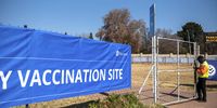 Security guard locking a gate at the Discovery mass vaccination site.(Photo: Alet Pretorius)