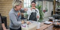 Annalize Louw, right, assists a group of American entrepreneurs during a muffin-baking session hosted at Môreson wine farm. Louw has been a cornerstone of Isabelo since the beginning. Photo: Christi Nortier