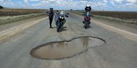 1000 potholes and 1 was bigger than this. The scenery, the landscape, the massive sky, the highfield storms, the howling wind, the absolute isolation, the silence, the heat, the cold, the rain, the hail, makes traveling this road worth it. Photographer: Terry Donnelly 