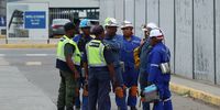 A group of miners talking to security personnel after emerging from 11C shaft at Impala Platinum mine in Rustenburg,11 miners lost their lives and 75 were injured in an accident on 27 November 2023. (Photo: Felix Dlangamandla)
