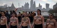 LONDON, ENGLAND - MARCH 08: (EDITOR'S NOTE: This image contains partial nudity.) Topless female Extinction Rebellion activists block Waterloo Bridge in a demonstration on International Women's Day on March 8, 2020 in London, England. International Women's Day is celebrated on 8th March every year and is a global day celebrating the social, economic, cultural and political achievements of women whilst serving as a focal point for women's rights. (Photo by Chris J Ratcliffe/Getty Images)