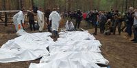 Mass exhumation scenes from a pine forest at the edge of Izyum where Ukrainian emergency service workers have been uncovering makeshift graves. (Image: Supplied)