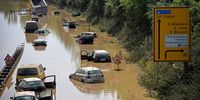 epa09619038 Wrecked cars and trucks are flooded on the B265 federal highway in Erftstadt, Germany, 17 July 2021. Large parts of Western Germany were hit by heavy, continuous rain in the night to Wednesday, resulting in local flash floods that destroyed buildings and swept away cars.  EPA-EFE/SASCHA STEINBACH