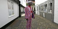 epaselect epa06746560 A royal fan in a Union Jack outfit poses one day ahead of the royal wedding ceremony of Britain's Prince Harry and Meghan Markle at St George's Chapel in Windsor Castle, in Windsor, Britain, 18 May 2018.  EPA-EFE/NEIL HALL
