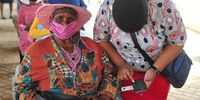 A Limpopo department of health staff member assists an elderly resident of Tooseng village to register for the province's vaccination drive. (Photo: Lucas Ledwaba / Mukurukuru Media)