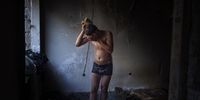 Akram, 16, takes a shower inside an abandoned building where he is living together with other Afghans in Bihac. Since the closure of the Serbian-Hungarian border to migrants, many have instead chosen to cross from Bosnia into Croatia. However, for many, the dream of a new life turns into a nightmare, and the United Nations High Commissioner for Refugees has called for investigations into reports of violence and excessive use of force. Yet still, every day, dozens of migrants attempt to cross into Croatia from the neighbouring Bosnian city of Bihac, recognisable by their backpacks full of clothes, food and water. The situation worsened over winter, with temperatures reaching minus 15°C, causing the closure of the Vucjak camp, where hundreds of people remained housed in tents. © Jose Manuel Lopez, Spain, Shortlist, Professional, Documentary Projects, 2021 Sony World Photography Awards