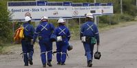 Miners walking outside the 11C shaft at Impala Platinum mine in Rustenburg,11 miners lost their lives and 75 were injured in an accident on 27 November 2023. (Photo: Felix Dlangamandla)