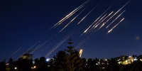 Missiles fired from Iran are pictured in the night sky over Jerusalem on June 14, 2025. (Photo: Menahem Kahana / AFP via Getty Images)