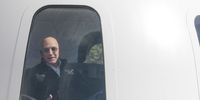 Jeff Bezos, chief executive officer of Amazon.com Inc. and founder of Blue Origin LLC, sits inside the high fidelity crew capsule mock up of the Blue Origin New Shepard system during the Space Symposium in Colorado Springs, Colorado, U.S., on Wednesday, April 5, 2017. Bezos has been reinvesting money he made at Amazon since he started his space exploration company more than a decade ago, and has plans to launch paying tourists into space within two years. Photographer: Matthew Staver/Bloomberg via Getty Images