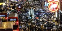 Demonstrators march on Des Voeux Road Central during a protest in Hong Kong. (Photo: Roy Liu / Bloomberg via Getty Images)