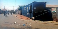 A closed spaza shop in Naledi with yellow police tape around it.  