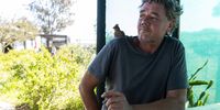 Jacques Nel, founder of the Owl Orphanage in Velddrif, with a red-faced mousebird on his shoulder. (Photo: Ashraf Hendricks)