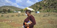 Mabotjane Thobejane carries the food hamper left for her brother who had gone into the mountains to look for food for safekeeping. (Photo: Lucas Ledwaba / Mukurukuru Media)