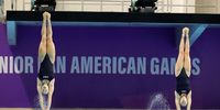 Sophia Versyl (L) and Anna Kwong of the United States compete in the women's 3m springboard diving category at the 2nd ASU 2025 Junior Pan American Games in Luque, Paraguay, 16 August 2025.  EPA/Juan Pablo Pino