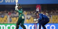 Chloe Tryon  bats as England wicketkeeper Amy Jones looks on. (Photo: Prakash Singh / Getty Images)