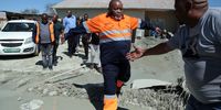 Minister of Mineral Resources and Energy Gwede Mantashe negotiates a puddle of mud during his visit to Charlesville in Jagersfontein on 13 September 2022. (Photo: Felix Dlangamandla)
