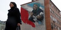 epaselect epa09908355 A woman walks in front of an apartment block with a patriotic mural by Russian artist Ilya Demchinko in support of the 'special military operation' in Ukraine, the town of Reutov, outside Moscow, Russia 25 April 2022. Russian troops on 24 February had entered Ukrainian territory resulting in fighting and destruction in the country, a huge flow of refugees, and multiple sanctions against Russia.  EPA-EFE/MAXIM SHIPENKOV