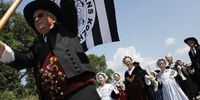Traditional dances are performed to cycling fans at the finish line of the stage prior to the finish of the 4th stage of the 105th edition of the Tour de France cycling race over 195km,  Sarzeau, France, 10 July 2018.  EPA-EFE/KIM LUDBROOK