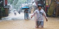People wade through flooded streets to buy food as heavy rain continues on November 3, 2025 in Hue, Vietnam. Central Vietnam has been hit by heavy rain that triggered flooding since October 26, killing at least 35 people. (Photo: Thanh Hue/Getty Images)
