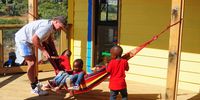 Children enjoy the new facilities at the recently completed Monang Pre School with one of the students who worked on the project. Photo: Lucas Ledwaba/Mukurukuru Media