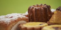 A provocative canelé, followed by a financier, a tarte tatin, chocolate madeleine and kourabiede, clockwise. (Photo: Marie-Lais Emond)