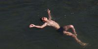 A man swims in a stream on the outskirts of Srinagar, the summer capital of Indian Kashmir, 10 June 2025, on a hot weather day.  EPA-EFE/FAROOQ KHAN