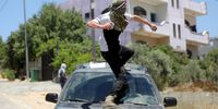 A Palestinian protester throws stones at Israeli troops during clashes after a demonstration against Israel's settlements on the lands of Kafr Qadoum village near the West Bank city of Nablus, 10 June 2022.  EPA-EFE/ALAA BADARNEH