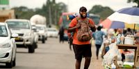 Joseph ‘Travel Mufasa’ Makowa makes his way through one of the more urban areas as he travels on foot across Zimbabwe. (Screengrab: Wild Africa Fund)