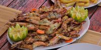 One of Mozambique’s most famous dishes is grilled prawns with lemon and piri piri. (Photo: Bridget Hilton-Barber)<br>