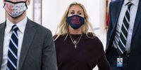 Representative Marjorie Taylor Green, a Republican from Georgia, center, wears a protective mask while arriving back to her office after speaking on the House floor at the Longworth House Office building on Capitol Hill in Washington, D.C., U.S., on Thursday, Feb. 4, 2021. House Democrats are heading into a showdown with Republicans today over GOP Representative Marjorie Taylor Greene's past promotion of conspiracies that threatens to provoke an escalating cycle of political retaliation. Photographer: Al Drago/Bloomberg via Getty Images