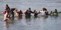 Migrants cross the Rio Grande in Eagle Pass Texas, USA, 22 September 2023. The Mayor of Eagle Pass Rolando Salinas Jr. estimated that 2,000 migrants crossed the border on 21 September, after about 3,000 migrants crossed into Eagle Pass on 20 September, according to the U.S. Representative Tony Gonzales. Mayor Salinas Jr. on 19 September declared a 'local state of disaster' in an emergency declaration issued after over 1,000 migrants crossed the border.  EPA-EFE/ADAM DAVIS