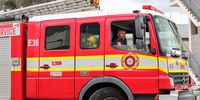 Senior firefighter Ivor Parenzee drives the fire engine at Ottery Fire Station, Cape Town. (Photo: Tamsin Metelerkamp)
